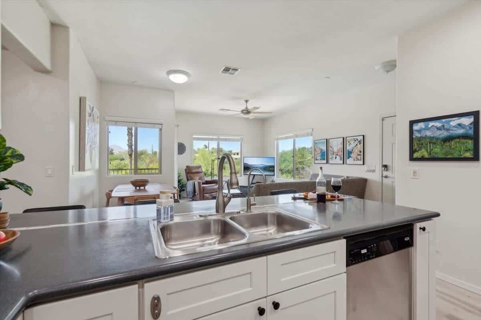 The Kitchen showcases a clean look, stainless steel appliances, and bar seating for four in a stylish, functional layout.