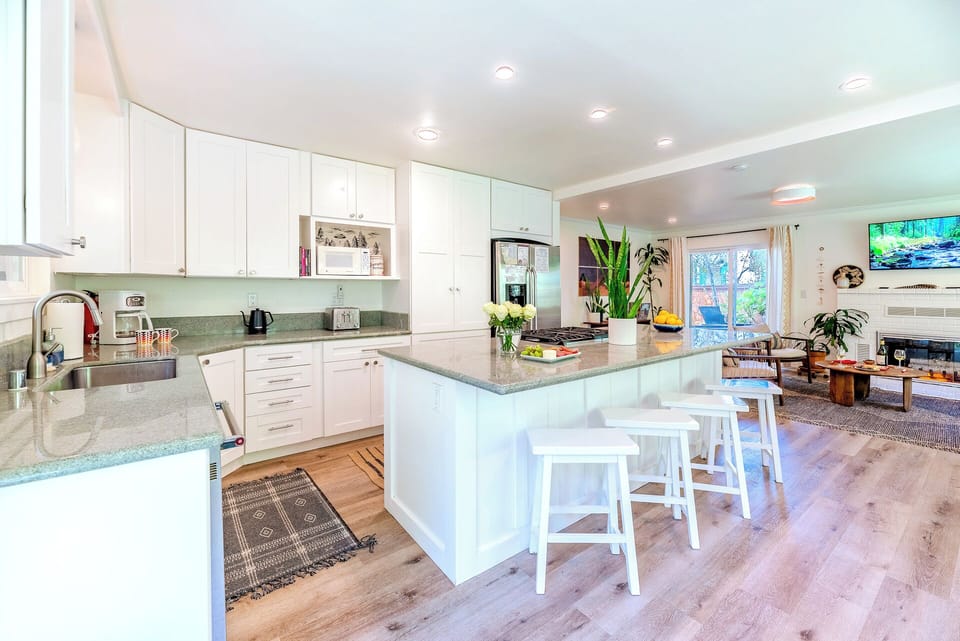 The kitchen features modern appliances, plenty of - counter space, and a full suite of cookware and utensils.