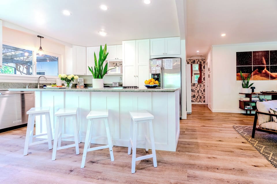 To the right of the kitchen is the small hallway leading to the - bath and bedrooms