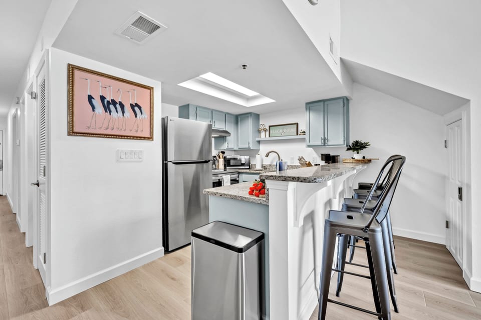 Your modern kitchen awaits with granite countertops, stainless appliances, and a breakfast bar perfect for morning coffee.