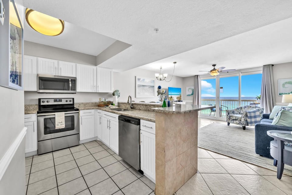 Your fully equipped kitchen opens to stunning beach views, creating the perfect backdrop for morning coffee and meal prep during your stay.