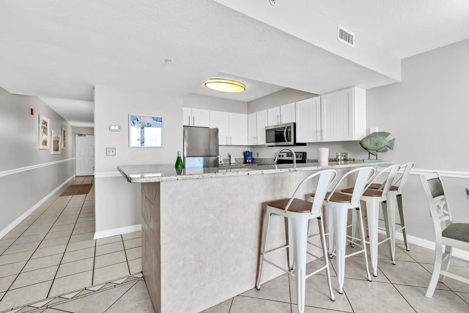 Your modern kitchen features granite countertops, stainless steel appliances, and a breakfast bar perfect for morning coffee or casual dining together.