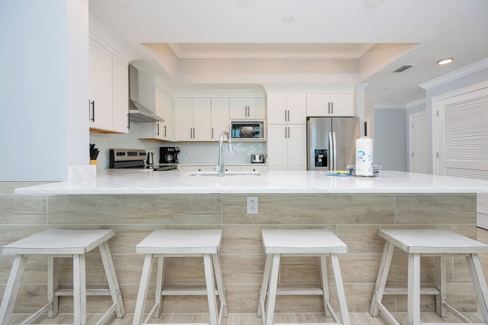 Gather around the sleek kitchen island with stylish stools, perfect for casual meals and morning coffee