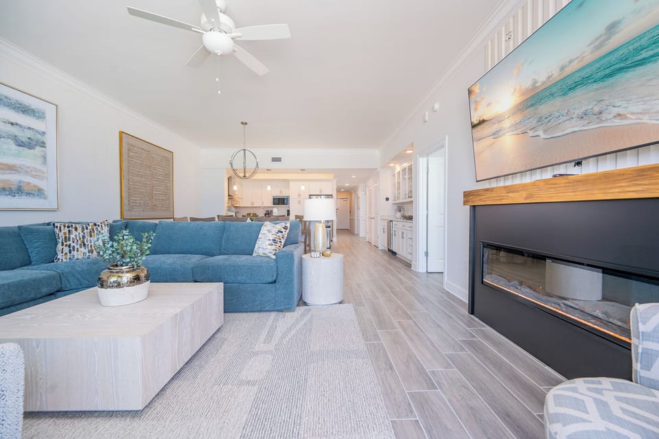 Unwind in this inviting living area after a day at the beach with a cozy fireplace and stream your favorite show