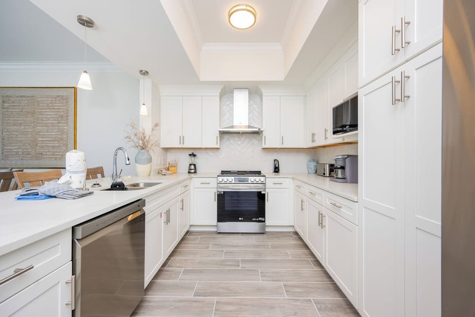 Prepare meals in this stylish kitchen, featuring modern appliances, a sleek design, and elegant accents