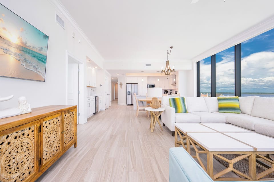 Relax in the spacious living area with a cozy sectional, stylish decor, and large windows offering beautiful views