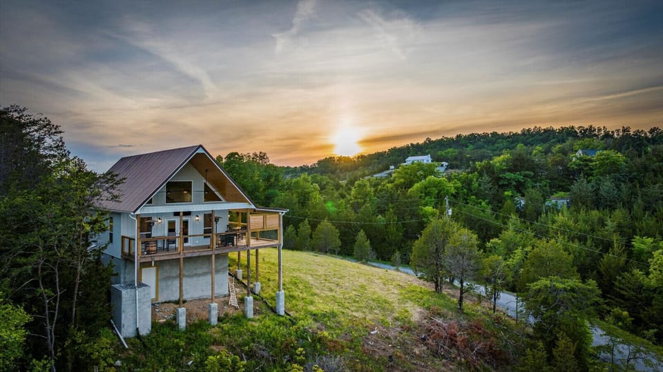 Watch the Smokies glow as the sun sets over Tennessee Whiskey Cabin