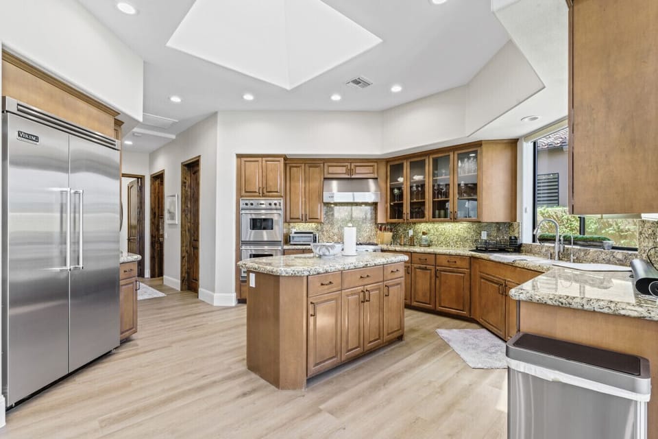 Spacious kitchen w/ large island, ample cabinetry & bright natural light