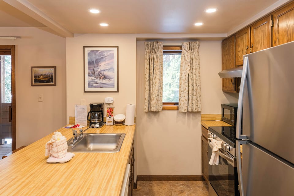 Your fully equipped kitchen invites home cooking with warm wood counters, stainless appliances, and everything you need for memorable meals.