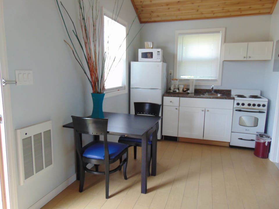Bungalow, 2 Queen Beds | Private kitchen | Fridge, microwave, coffee/tea maker, cleaning supplies