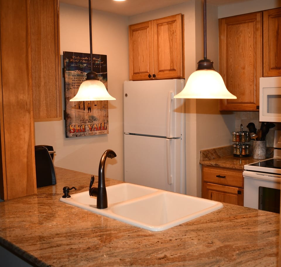 Updated kitchen with granite counters visible from the spacious living area.