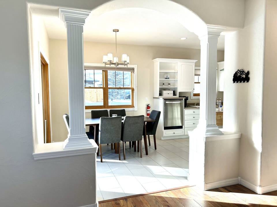 Dining room flows to a sliding glass door to the side yard and back yard w/ view
