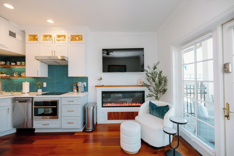 Cozy up in the comfortable living room featuring a Smart TV, elegant electric fireplace, and upscale finishes designed for a relaxing stay.