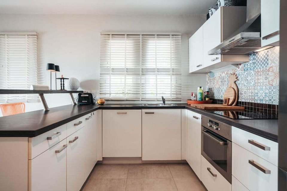 A fully equipped kitchen featuring essential appliances like a blender, coffee maker, freezer, kettle, refrigerator, microwave, and toaster—perfect for effortless meal prep, quick snacks, and daily comforts.