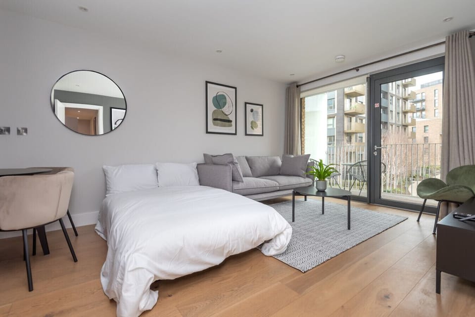 Bedroom and living space with doors to the balcony.