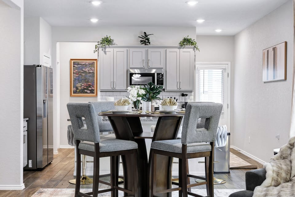 Spacious dining table that sits 4 with full tableware and silverware included.