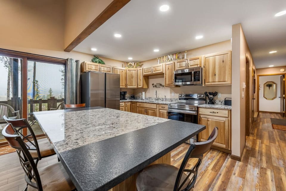 Enjoy meals together in the open-layout dining area with a fully stocked kitchen—perfect for cooking, gathering, and making memories.