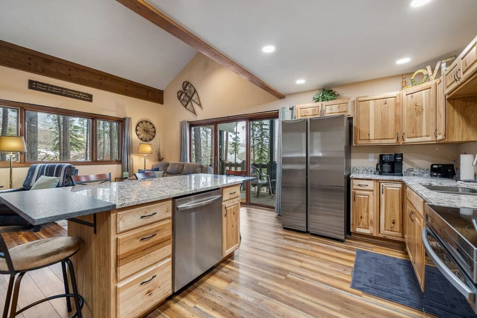 Fully stocked kitchen equipped with an oven, stovetop, double-door fridge, and everything you need for home-cooked meals.