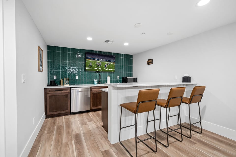 100 Bullwheel. - Basement wet bar with TV, dishwasher, barstools and a beverage fridge.