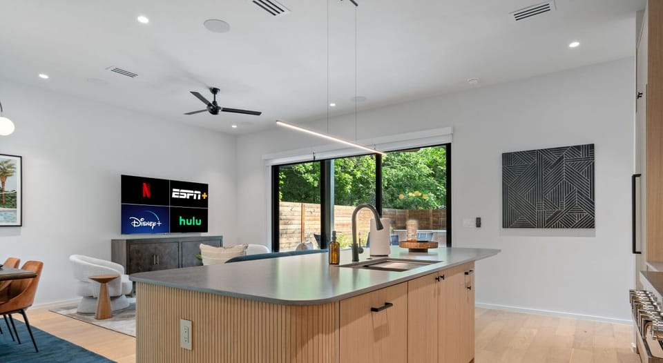 Life’s too short for boring views—this open-concept space serves style and streaming on a silver platter.
