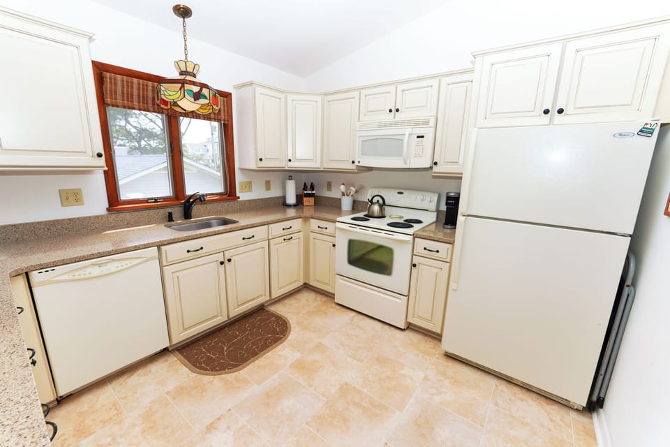 50 S. Anchorage - Kitchen Overview - Fully equipped kitchen with crisp white cabinetry, updated appliances, and plenty of counter space for meal preparation.