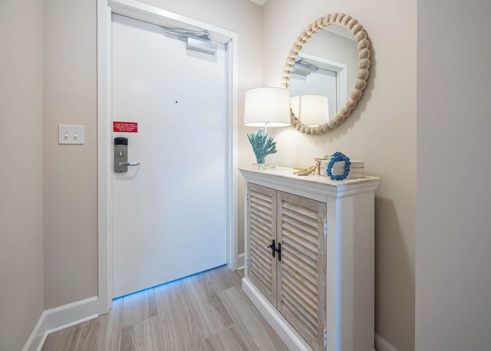 Step into a welcoming entryway featuring a stylish console, decorative accents, and soft lighting for a warm arrival