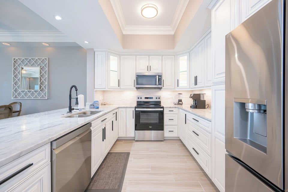 Prepare meals in this kitchen featuring elegant cabinetry, stainless appliances, and a stylish design