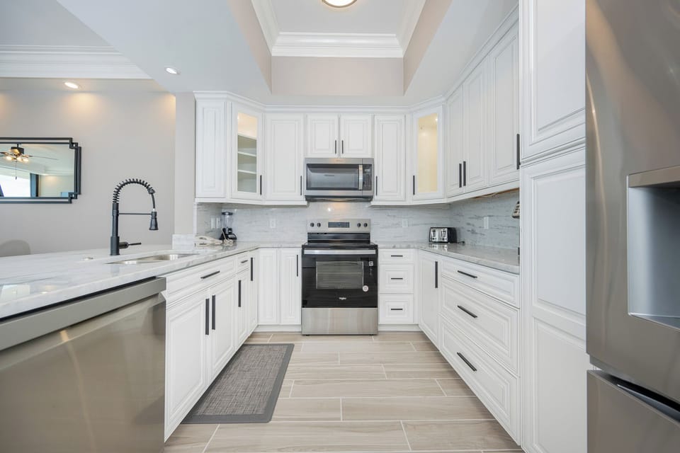 Prepare meals in this kitchen featuring elegant cabinetry, stainless appliances, and a stylish design