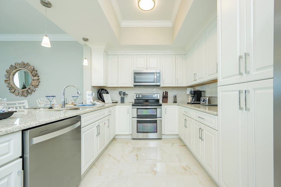 Prepare meals in this bright kitchen featuring modern appliances, stylish decor, and elegant cabinetry
