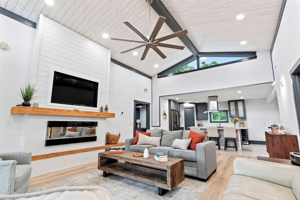 Relax in a stunning living space with soaring ceilings and coastal design