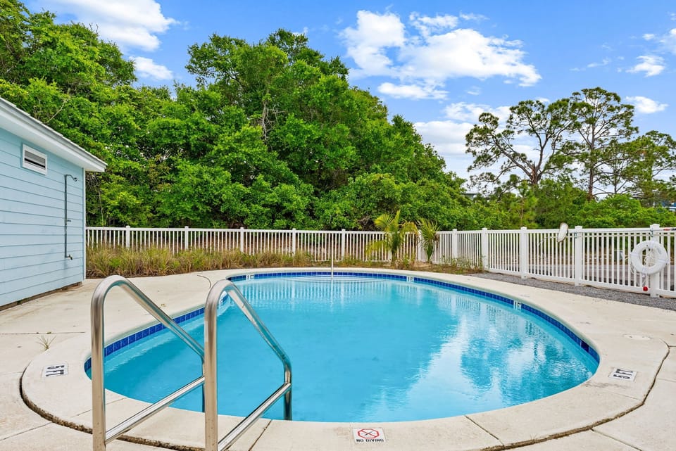 Your private oasis awaits with crystal-clear waters surrounded by lush greenery and peaceful privacy.