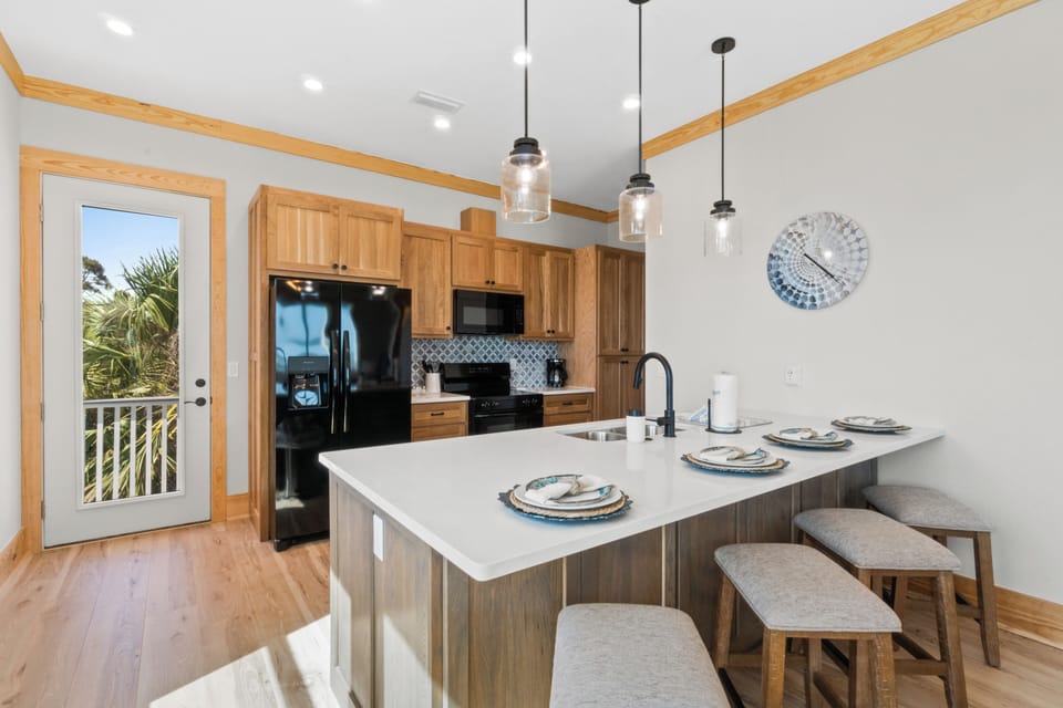Your fully-equipped kitchen invites you to cook memorable meals while natural light streams in from the balcony door.