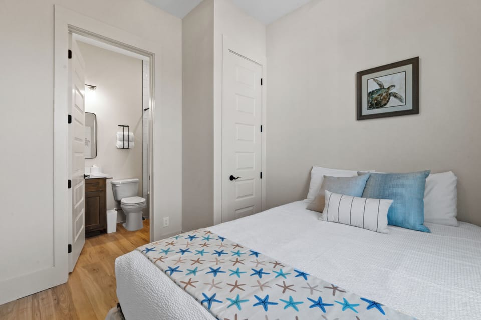 Your cozy coastal bedroom features crisp white linens, ocean-themed decor, and an ensuite bathroom for ultimate comfort.