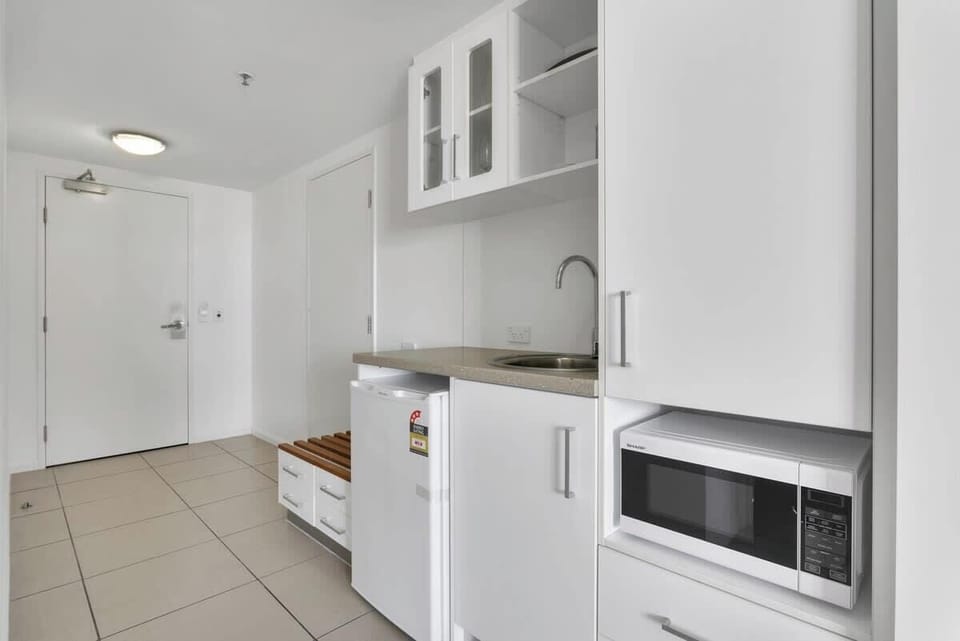 The studio is fitted with a compact kitchenette, replete with a fridge, microwave, kettle and toaster so you can whip up a light meal at home.
