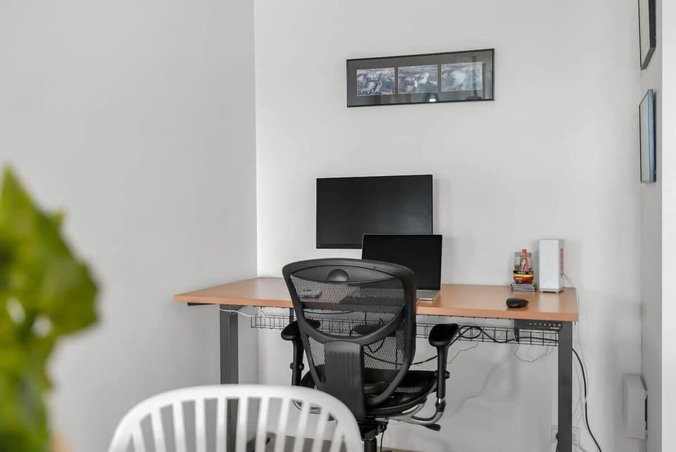 Whether working remotely or checking in on emails, a quiet nook with a monitor, ergonomic chair and desk ensures comfort and productivity.