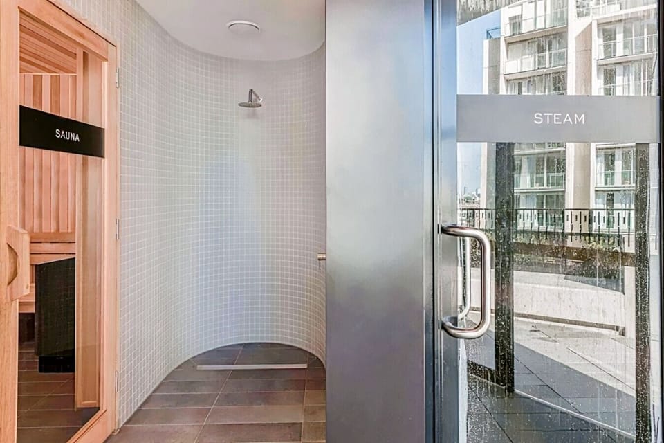 A dedicated wellness area with both a cedar sauna and a separate steam room side by side. Guests have access to a full spa-style recovery space without leaving the building.