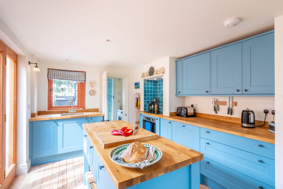 Ground Floor: Kitchen with an island, dishwasher, oven and microwave