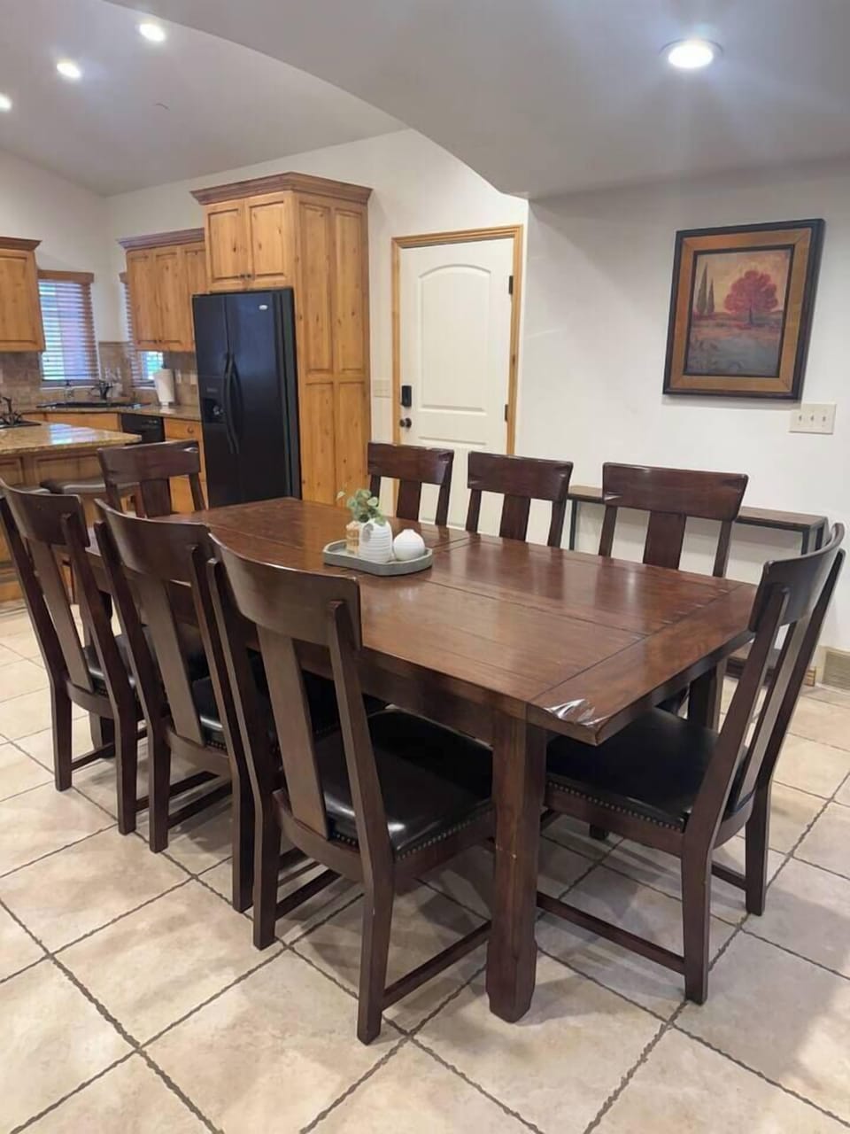 Spacious dining area with a large table that seats 8, ideal for family-style meals and gatherings.