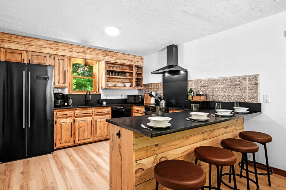 Black, honed granite and new appliances. Touches or torched-burnt wood and antler chandeliers. Breakfast bar seats 5! Keurig starter coffee pods provided.