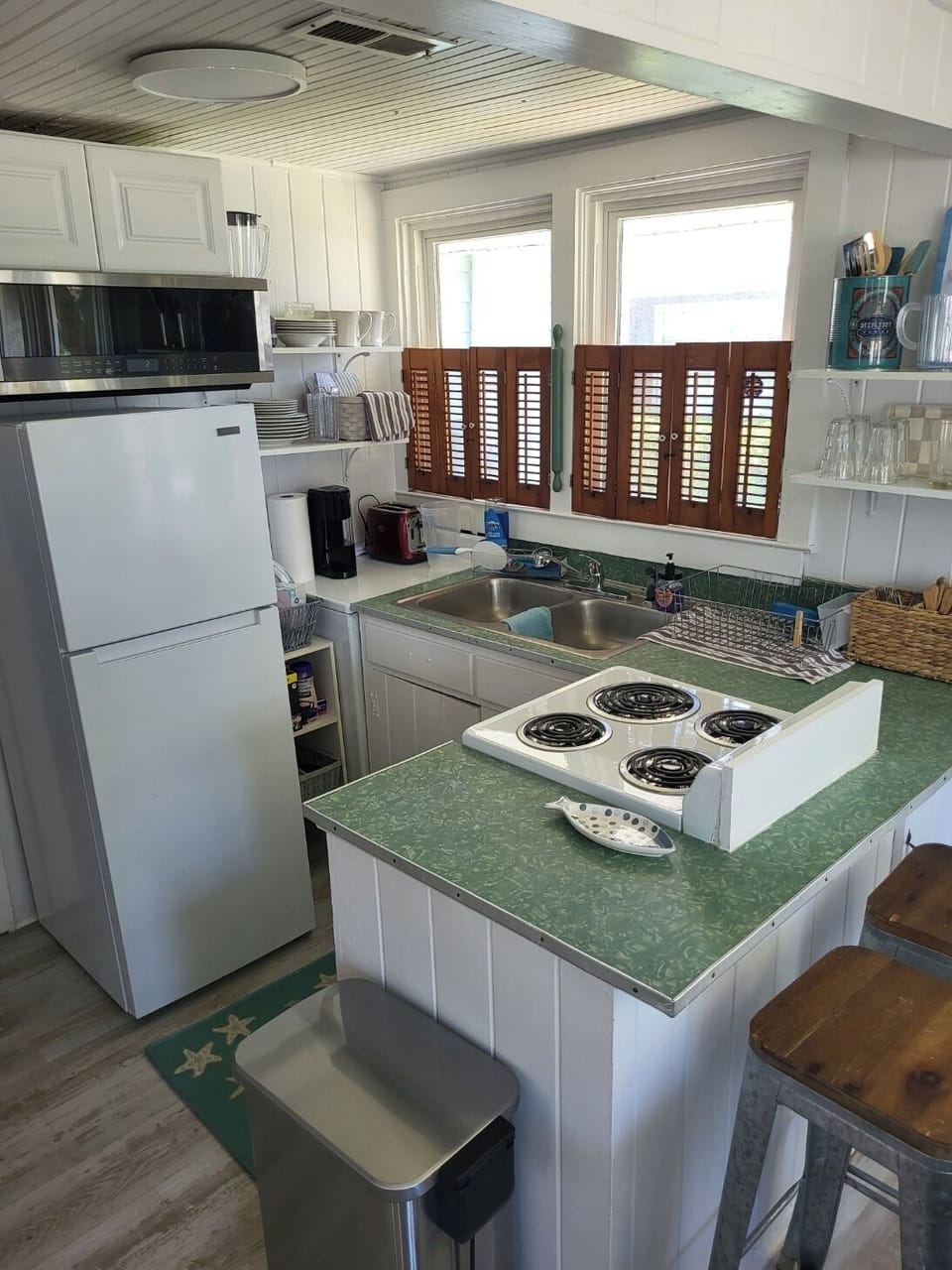 Compact kitchen with everything you need for cooking, serving.  2 barstools.