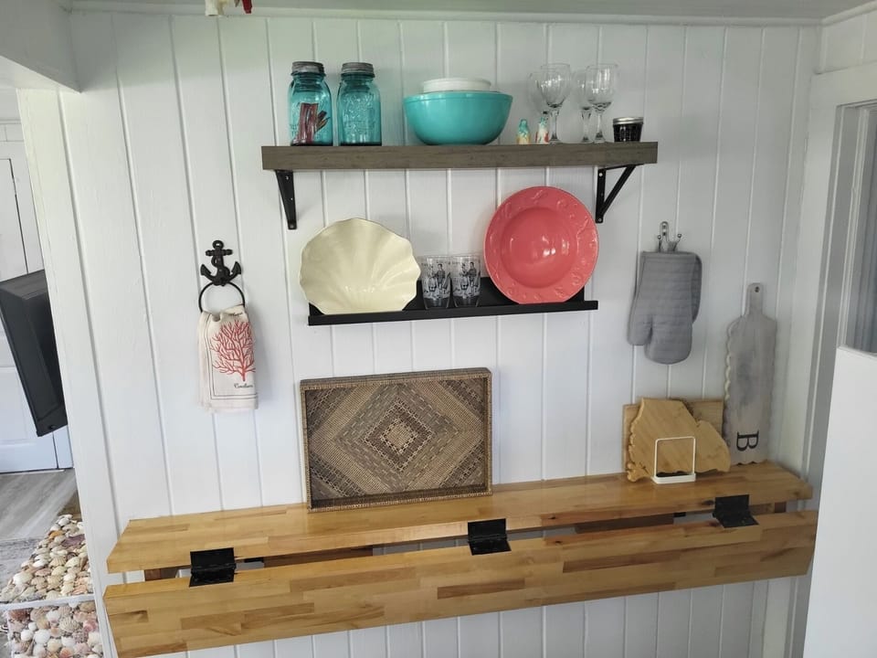 Drop down Butcher Block Counter. Lots of serving dishes for your use.