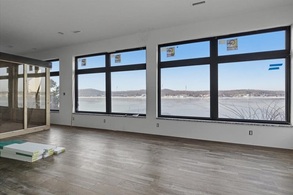 The primary suite features amazing lake views, a spacious room with king bed, queen bed, and a sauna.