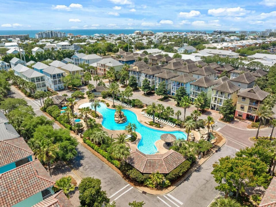 Take a dip in the community pool and you`ll understand why everyone here can`t stop smiling—the beach is literally right there beyond those rooftops.