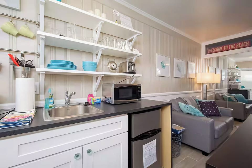 Enjoy a well-stocked kitchen with open shelving and modern appliances. (Edgewater C)