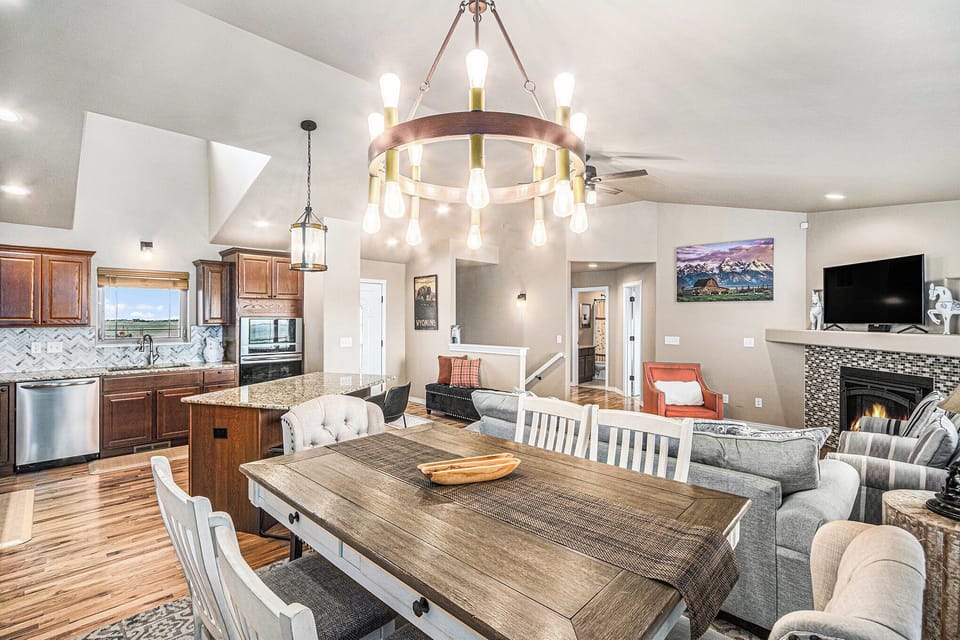 - Farmhouse dining space features a rustic wood table, chandelier lighting, and open layout
- Positioned between the kitchen and living room for easy mealtime flow
- Bright, airy feel makes this a favorite gathering spot for all guests

