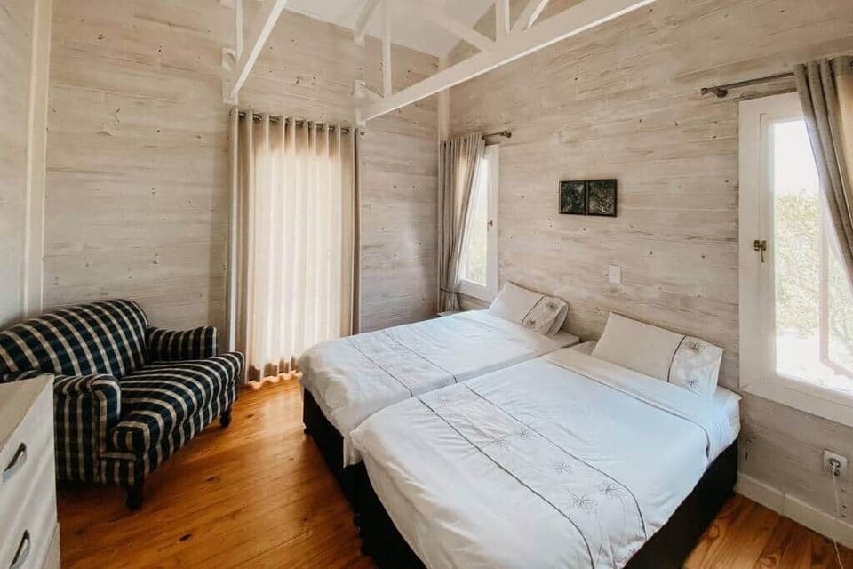 2 identical bedrooms - each bedroom includes 2 single beds, 1 dresser, and 1 private bathroom
