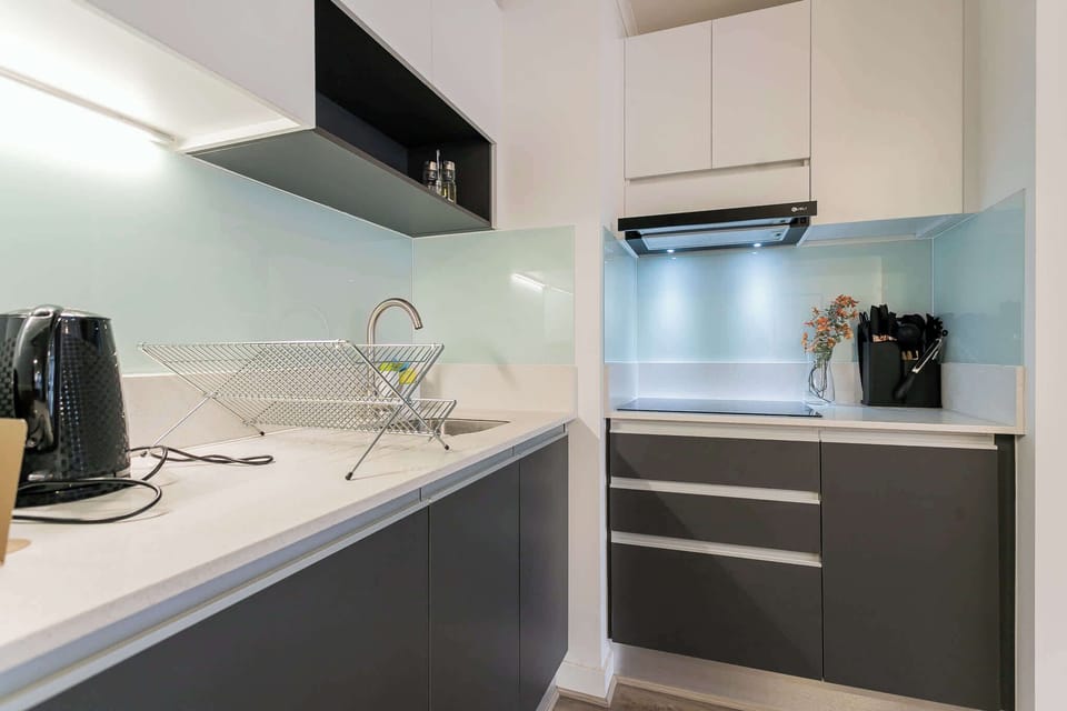 Experience culinary delight in this modern kitchen, featuring sleek design and all the essentials for your cooking needs.