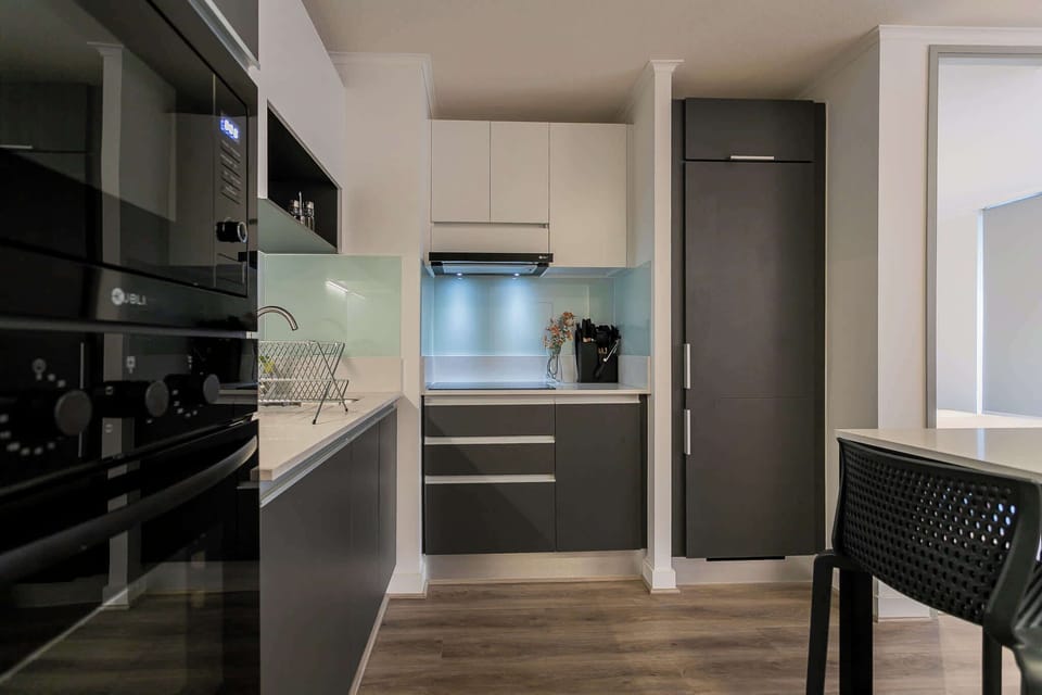 Sleek and modern kitchen with stylish cabinetry and ample lighting, perfect for culinary adventures.