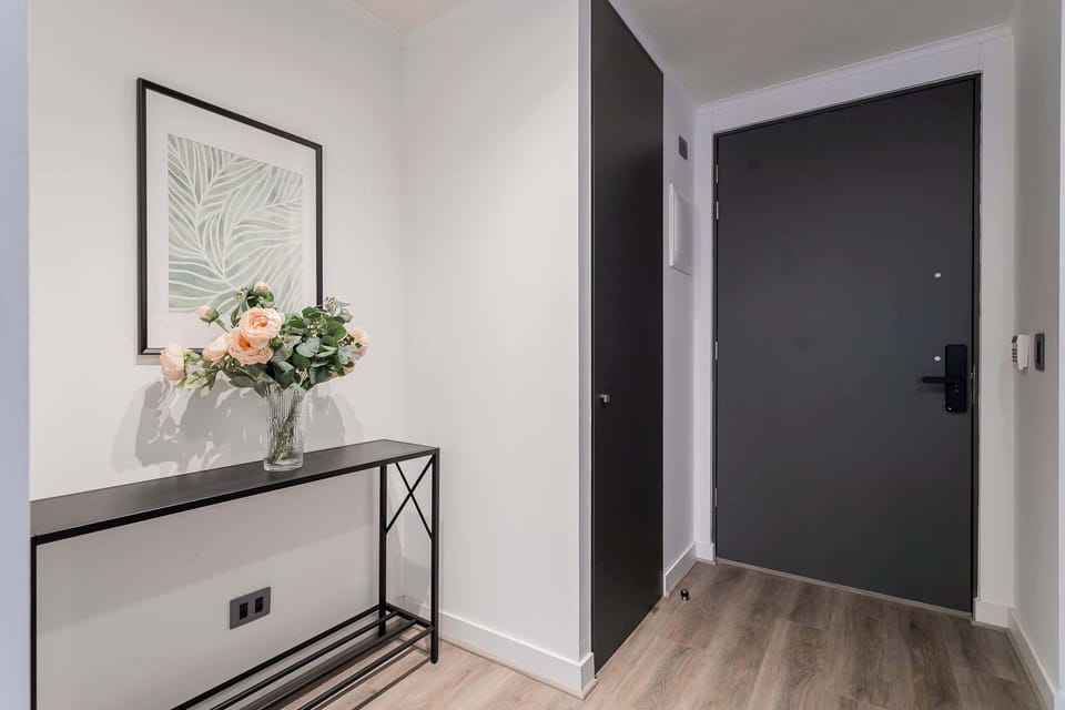 Welcome to your stylish retreat! This modern entryway sets the tone for a chic and comfortable stay.