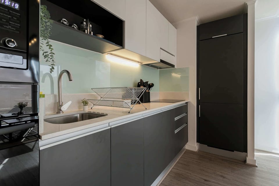 Experience culinary delight in this sleek, modern kitchen with top-notch amenities and stylish design.